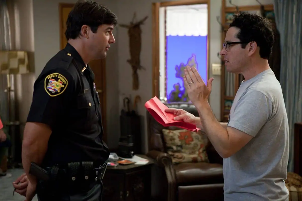 Left to right: Kyle Chandler (as Jackson Lamb) discuses a scene with director/writer/producer J.J. Abrams on the set of SUPER 8, from Paramount Pictures.