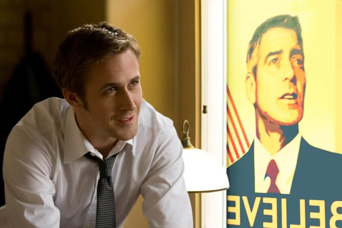 Ryan Gosling (left) with George Clooney (right, poster) stars in Columbia Pictures' IDES OF MARCH.