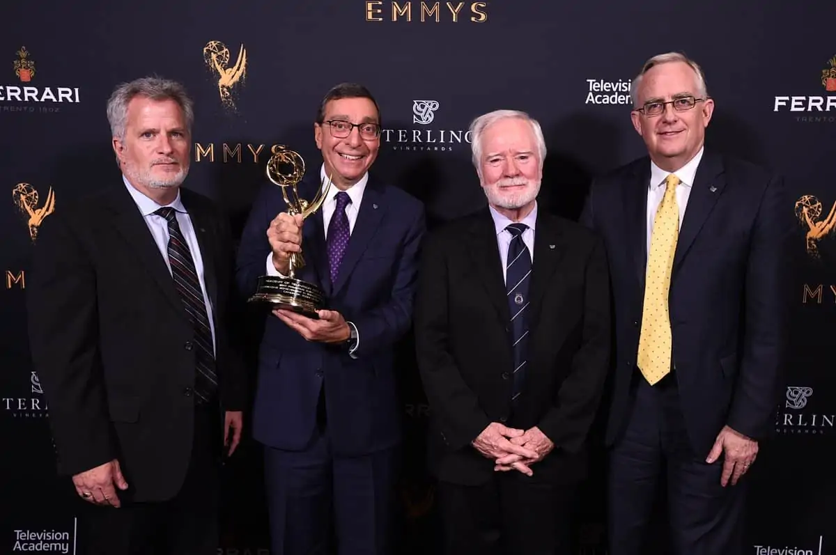 Tim Smith, from left, Elliot Peck, Larry Thorpe, and Scott Antaya pose with the Engineering Emmy Award for Canon 4k Zoom Lenses