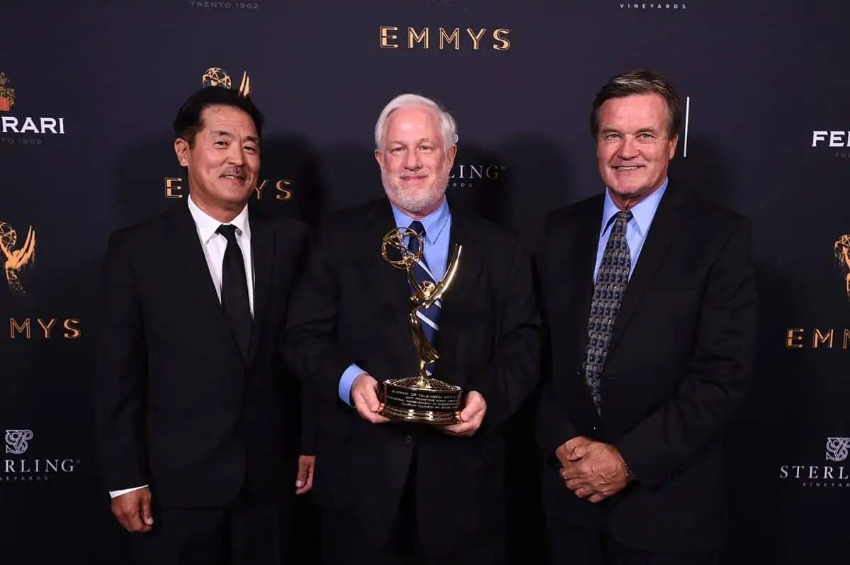 Miles Shozuya, from left, Gordon Tubbs, and Chuck Lee pose with the Engineering Emmy Award for Fujifilm Fujinon 4K Zoom Lenses
