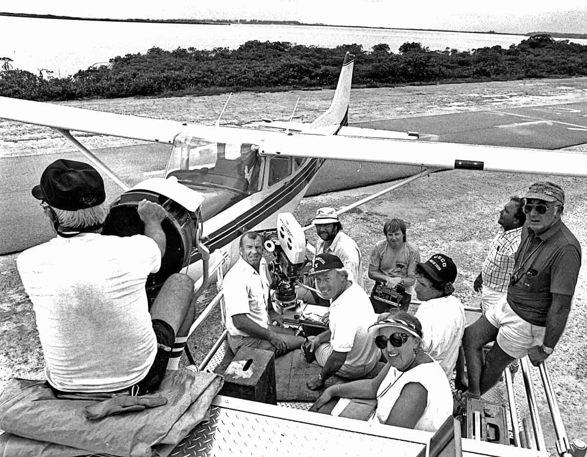 <em>Licence To Kill</em>... on location at Key West, Florida Keys, with his usual crew: (l-r) Mike Frift (camera operator), Frank Elliot (focus puller) and Simon Mills (clapper loader). Director John Glen sits behind the camera, and June Randall (continuity) keeps an eye on everyone