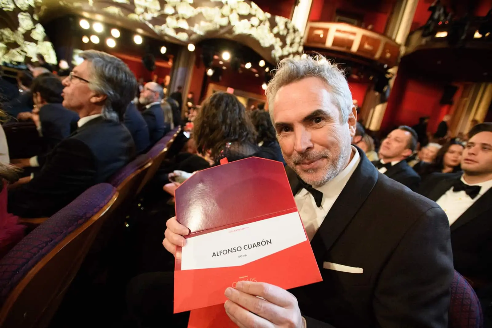 Alfonso Cuarón poses with the winning envelope for achievement in cinematography. Image: Richard Harbaugh / ©A.M.P.A.S.