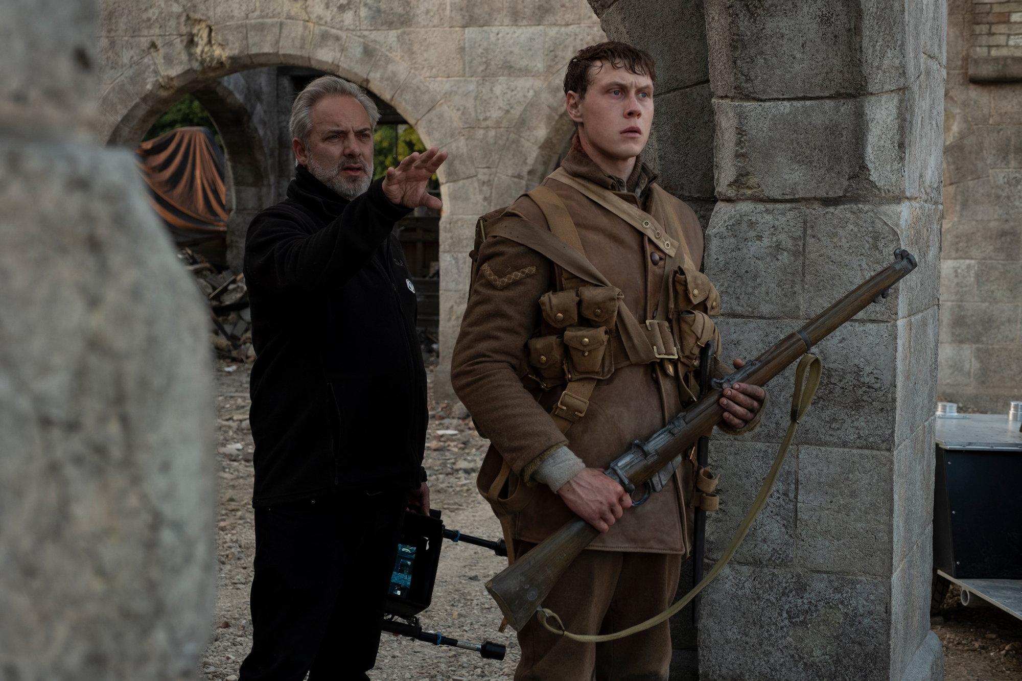 (from left) Director Sam Mendes and George MacKay on the set of Mendes' new epic, "1917."