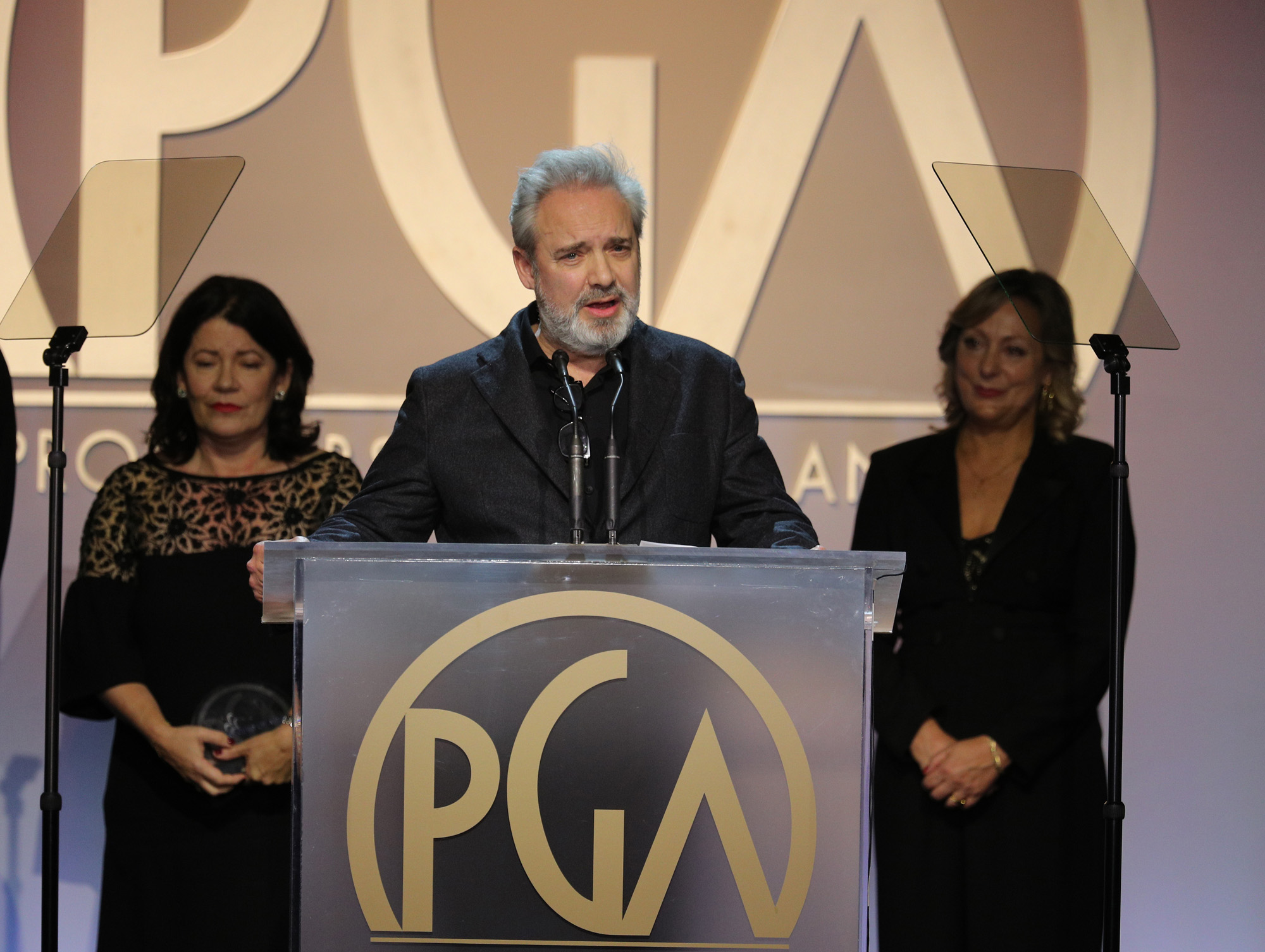 Sam Mendes, centre, accepts the Darryl F. Zanuck Award for outstanding producer of theatrical motion pictures at the 31st Annual Producers Guild Awards. Photo by John Salangsang/Invision