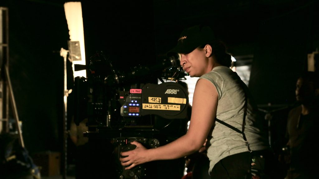 Nathalie Pitters looking through a camera