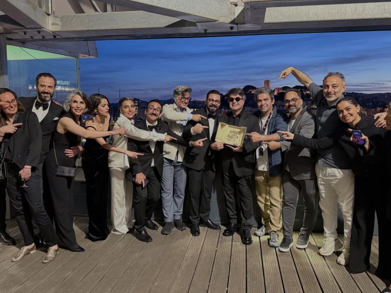 A group of people gathered around an award
