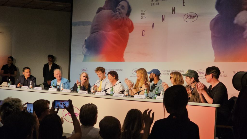 A group on a panel sat clapping