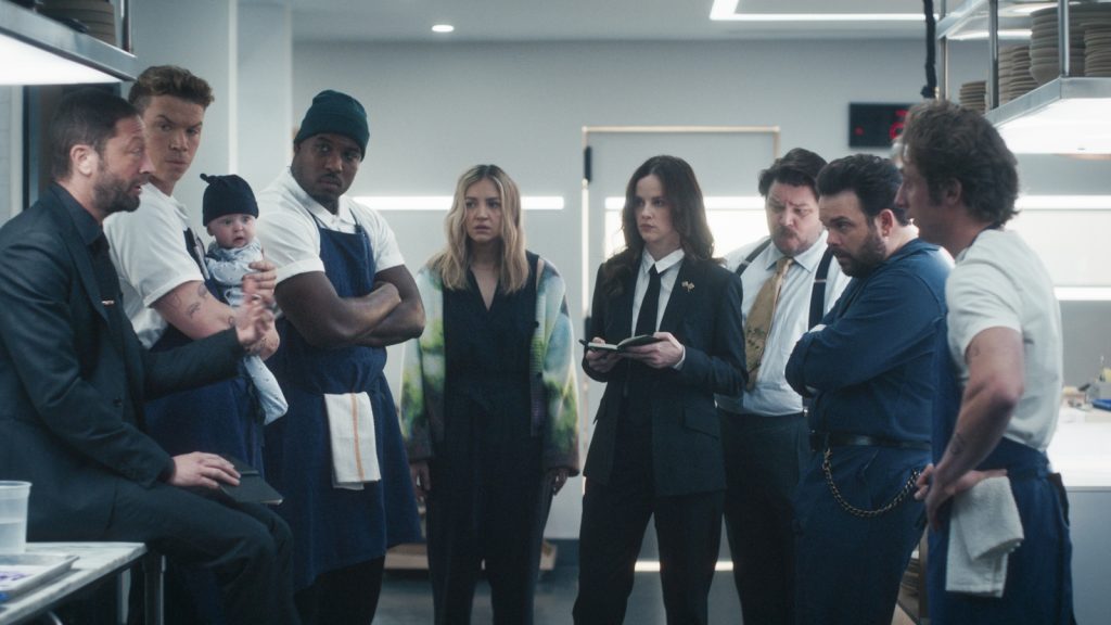 A group of people gathered in a kitchen