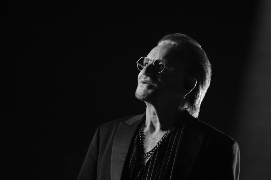 Bono looking up in glasses