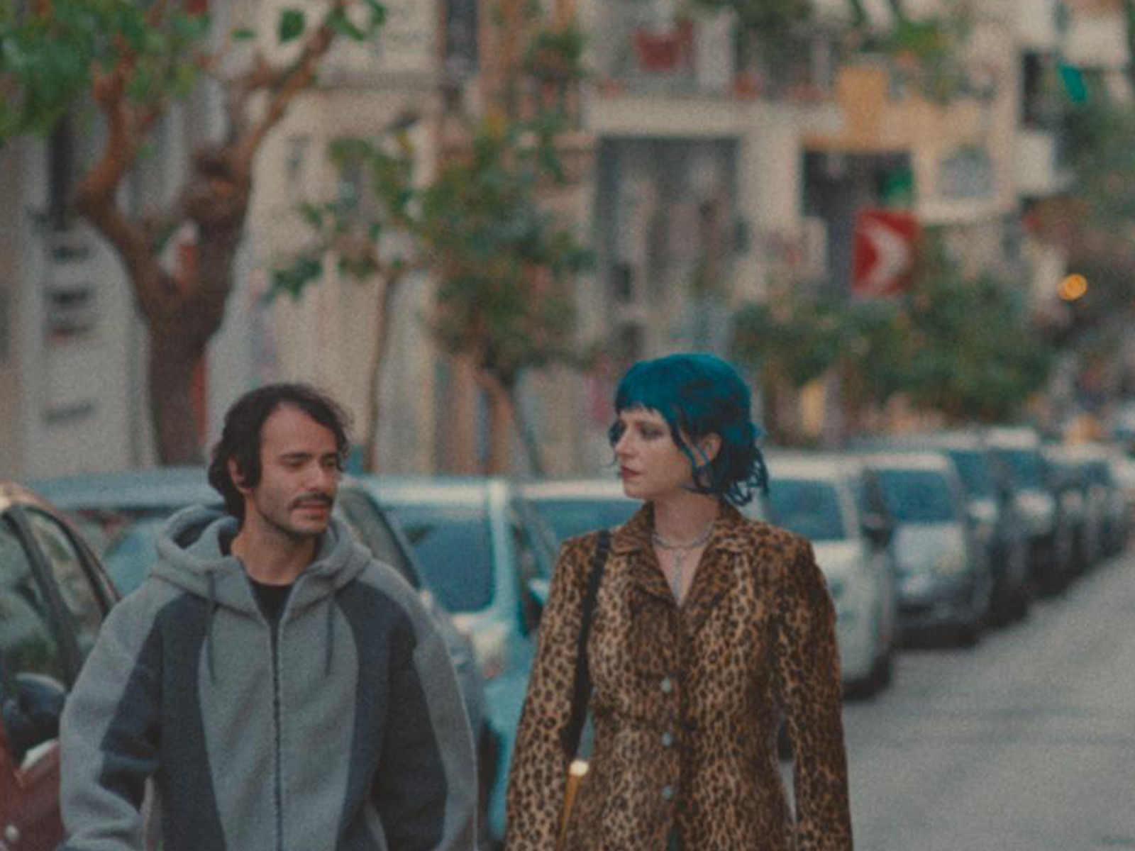 How to Shoot a Ghost still showing two people walking in the street