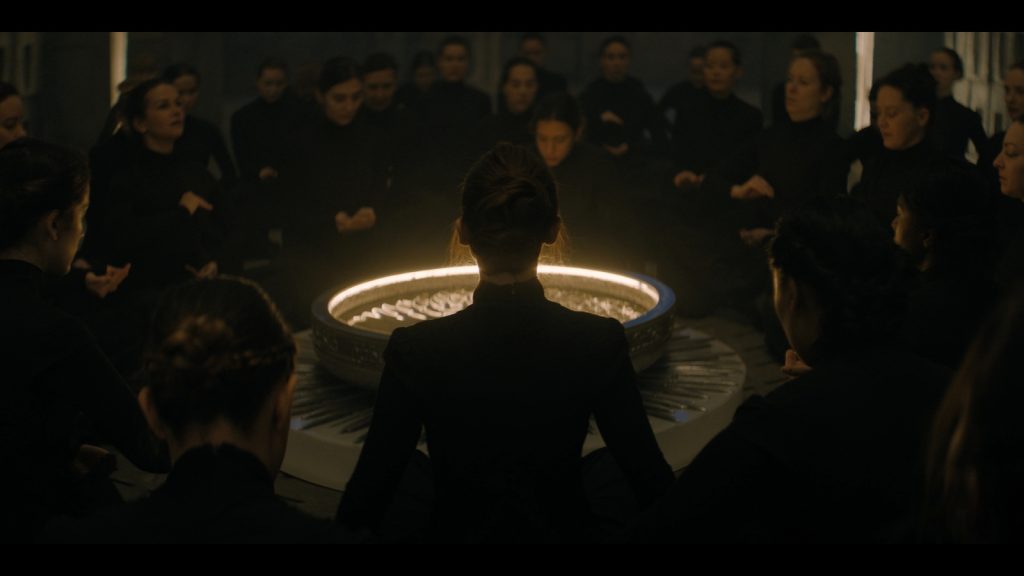 People gathered around a dim light