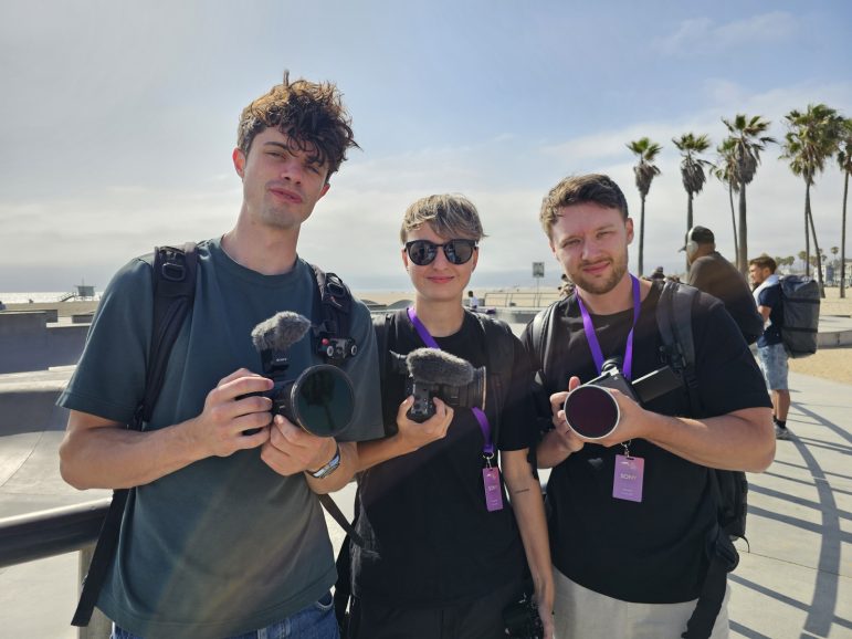 Three men holding cameras
