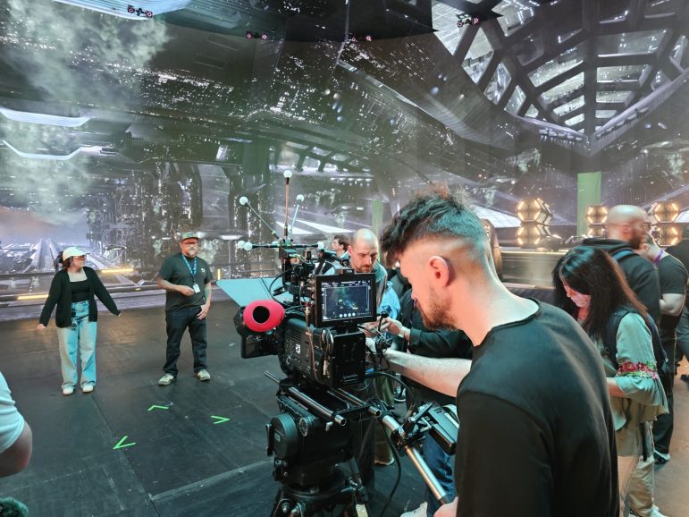 A group of young filmmakers at work in a studio