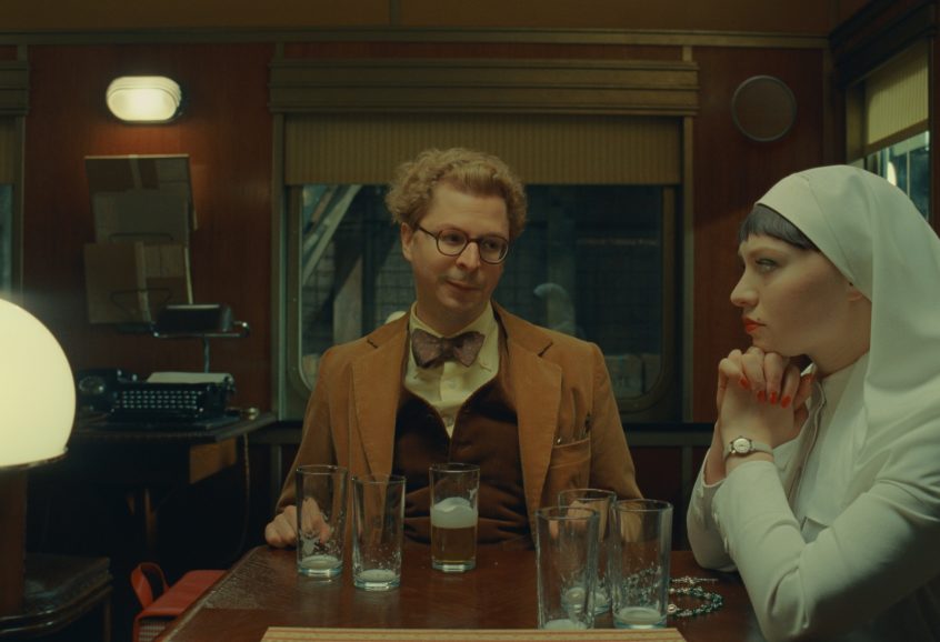 Two people sat at a table looking awkward