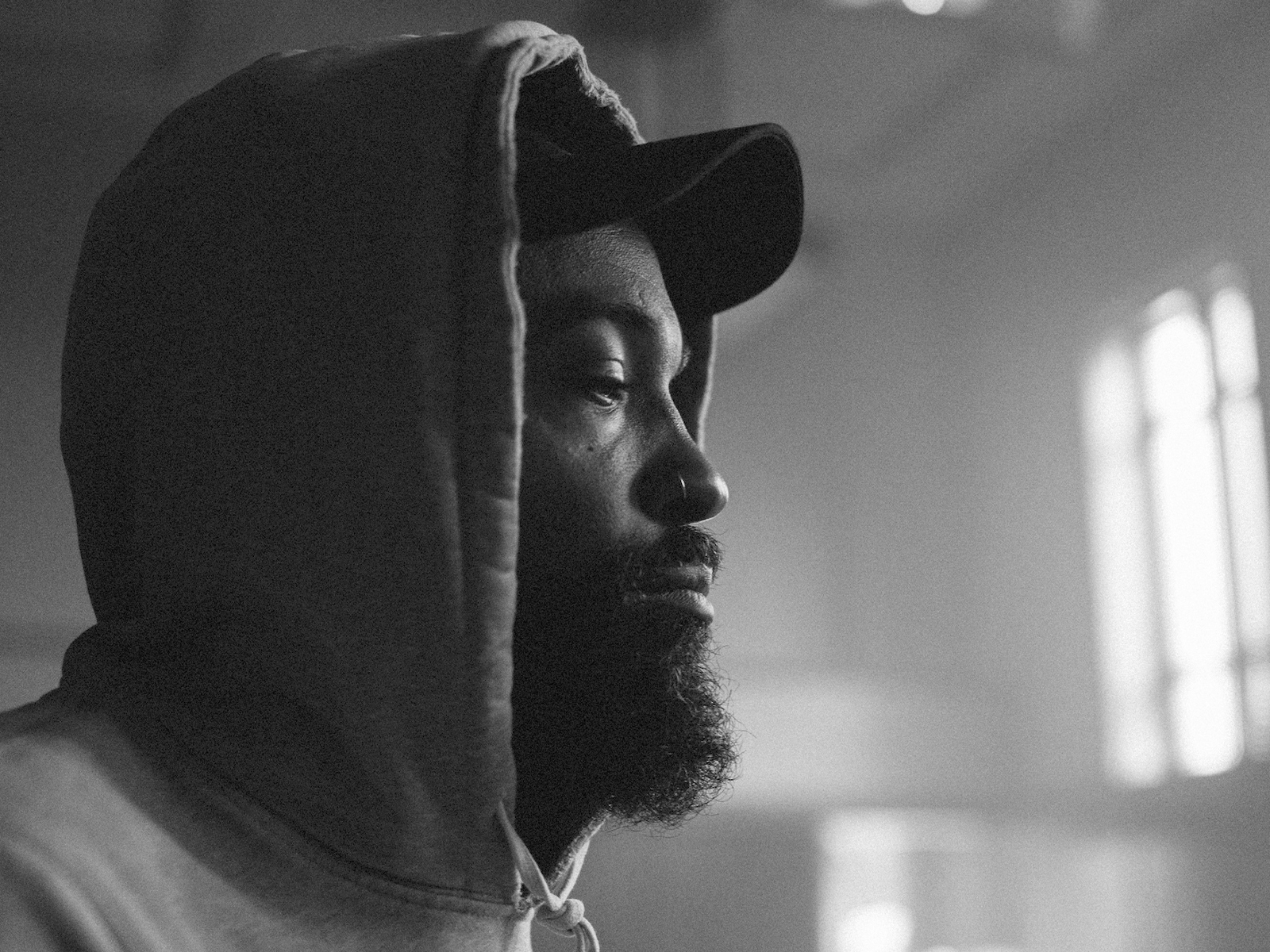 Bradford Young ASC in a hoodie and cap