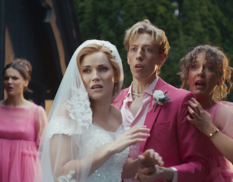 A wedding scene showing people looking shocked