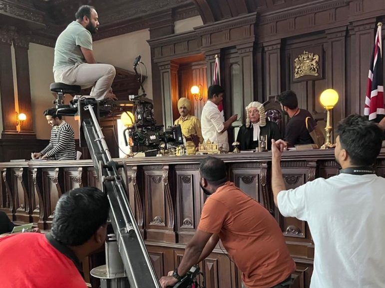 Film crew on set in a courtroom