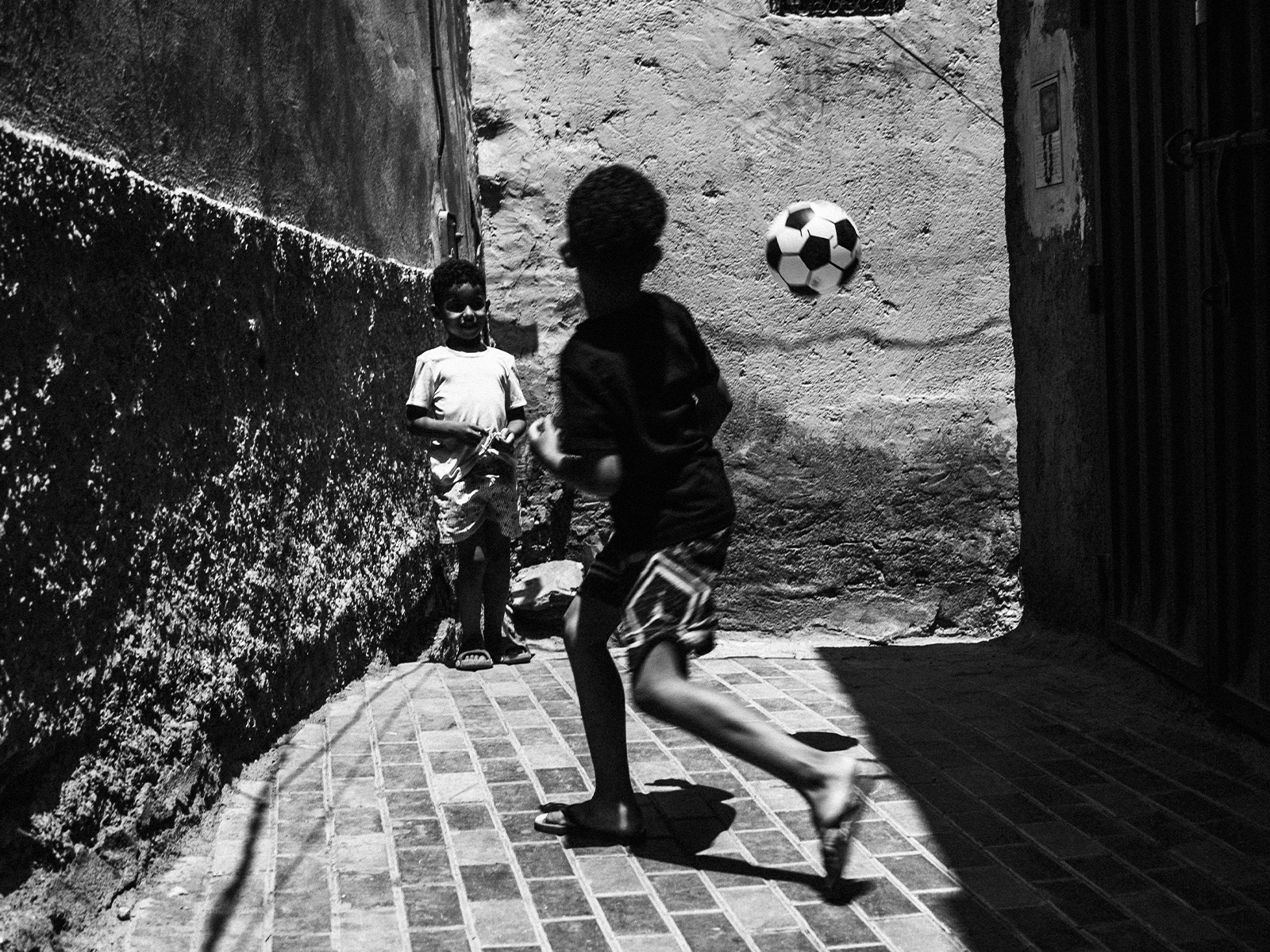 Two boys playing football