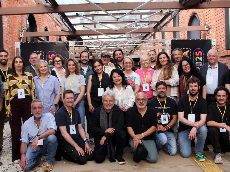 A group of people gathered together posing for camera