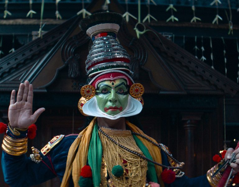 A still showing a person holding their hand up