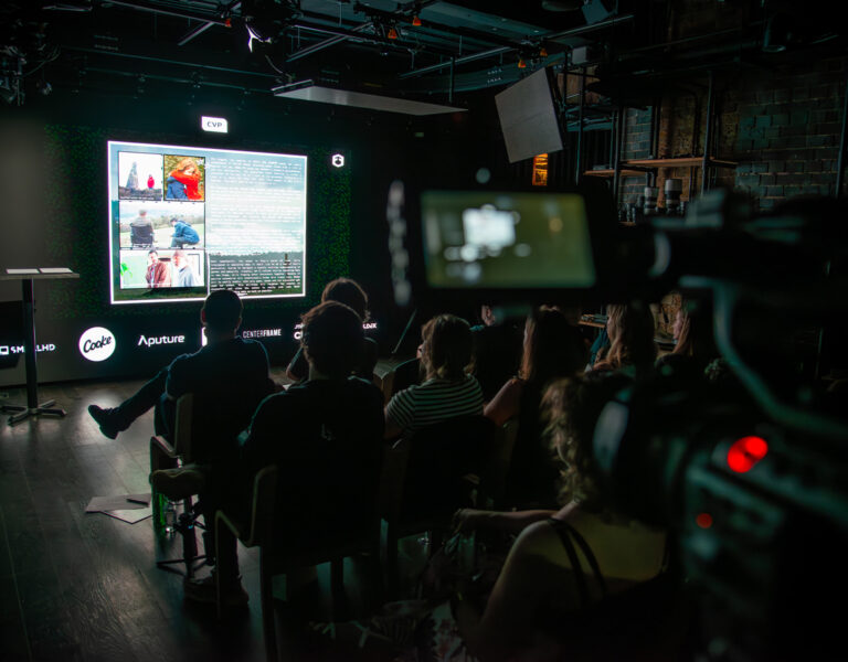 People sat watching a screen