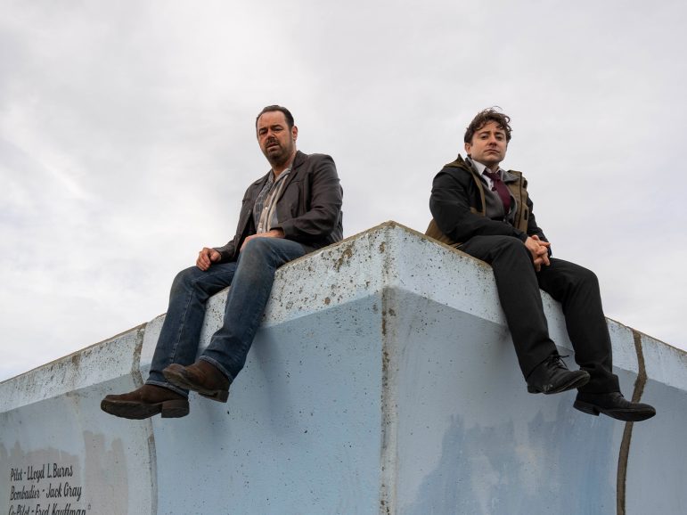 Two people sat on a roof