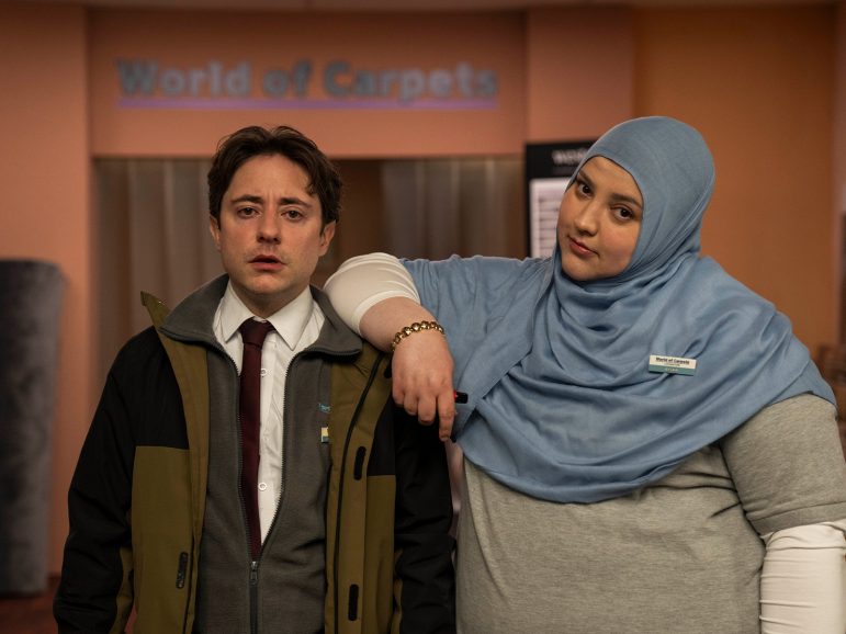 Two people stood looking into camera in World of Carpets