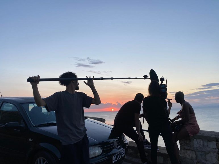 Film crew by the sea