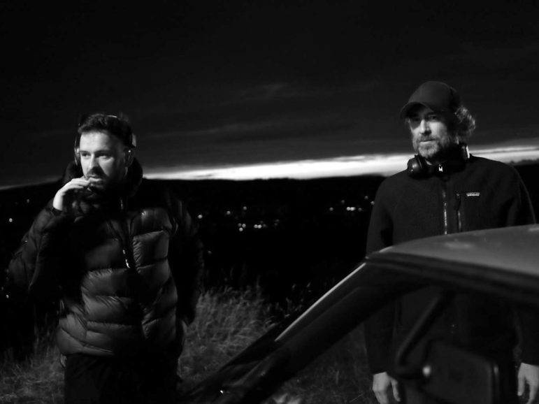 Two people stood by a car