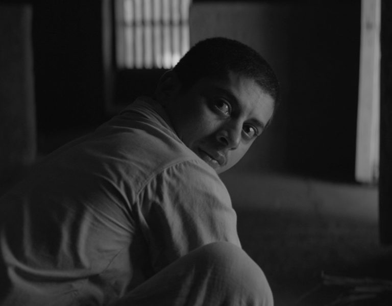 A person looking backwards, towards camera