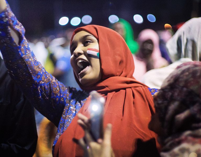 A still from Sudan Remember Us showing a woman celebrating