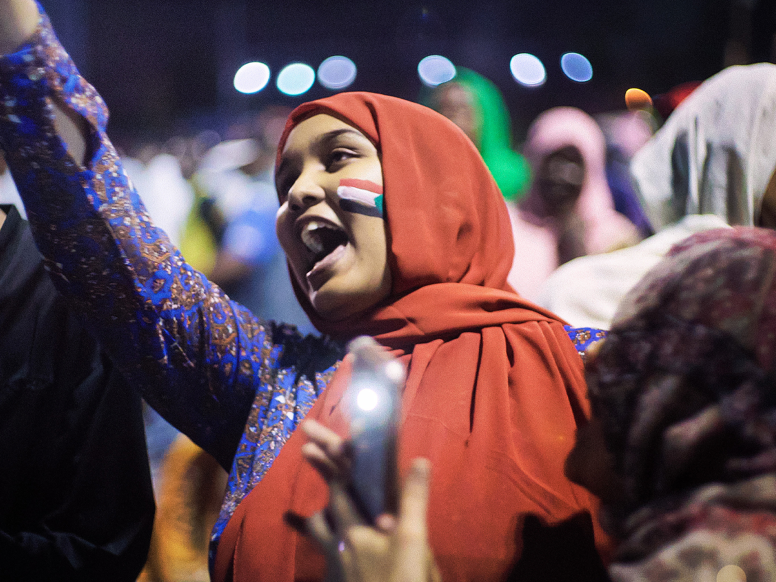 A still from Sudan Remember Us showing a woman celebrating