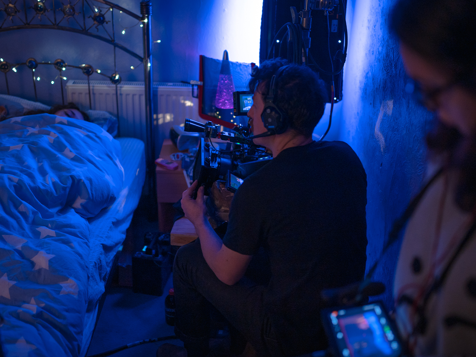 A camera operator shooting a bed