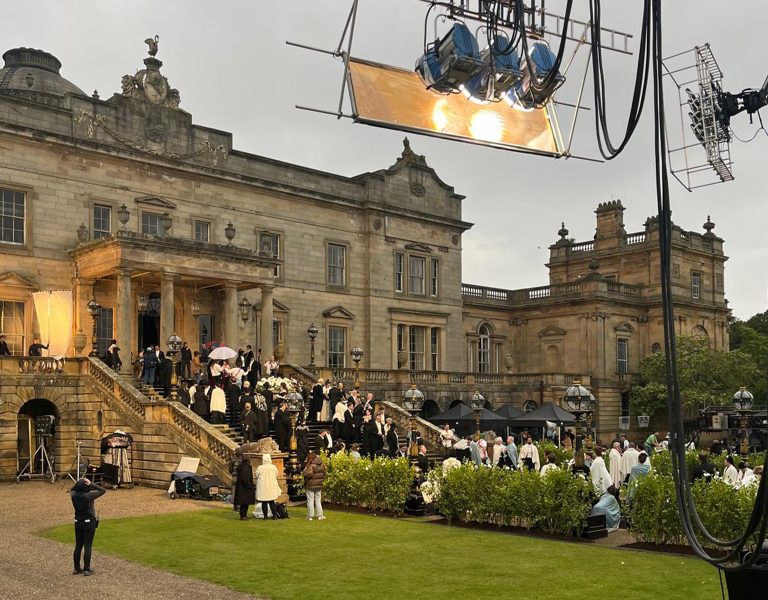 People gathered in period attire on a film set