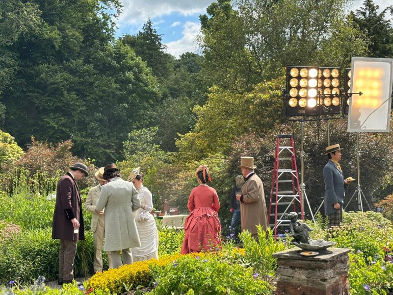 People dressed in period attire on a film set