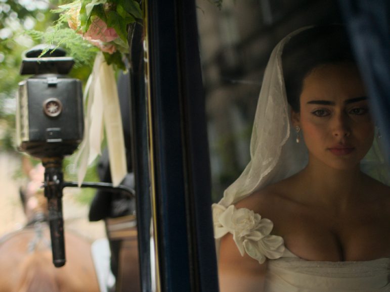 A woman in a wedding dress looking pensive