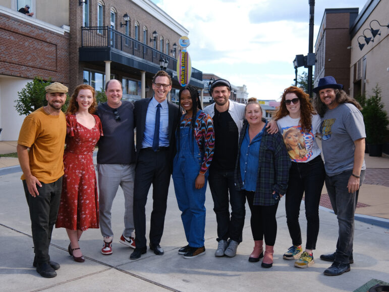 Cast and crew posing together