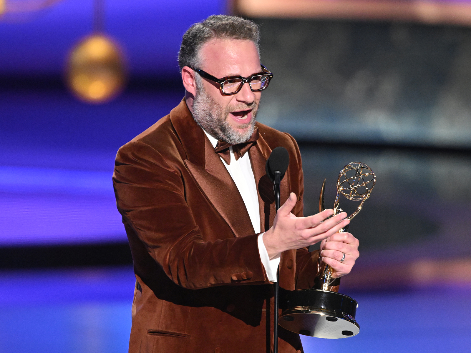 Seth Rogen on stage with an award