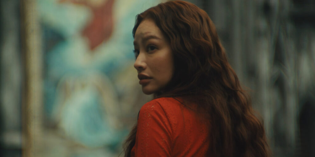 A woman in red looking shocked