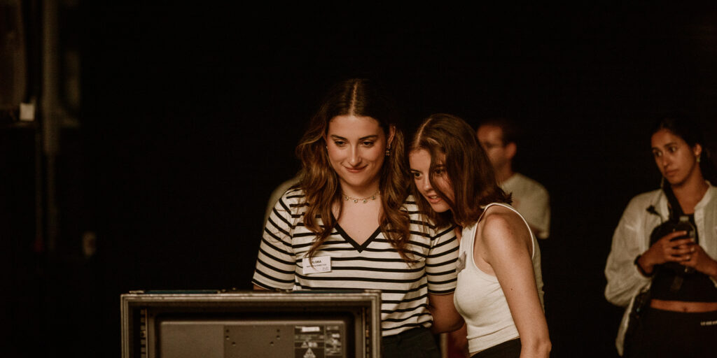 Film crew gathered around a monitor
