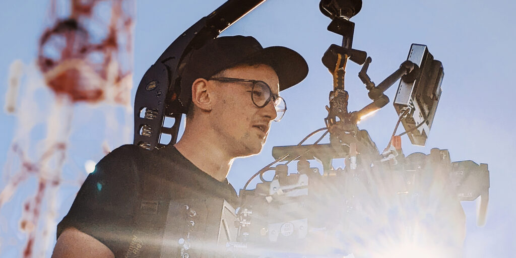 Josh Carrington Birch operating a camera in the sun