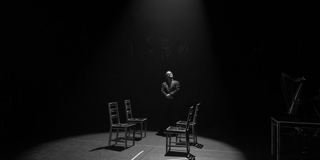 Bono stood between two chairs