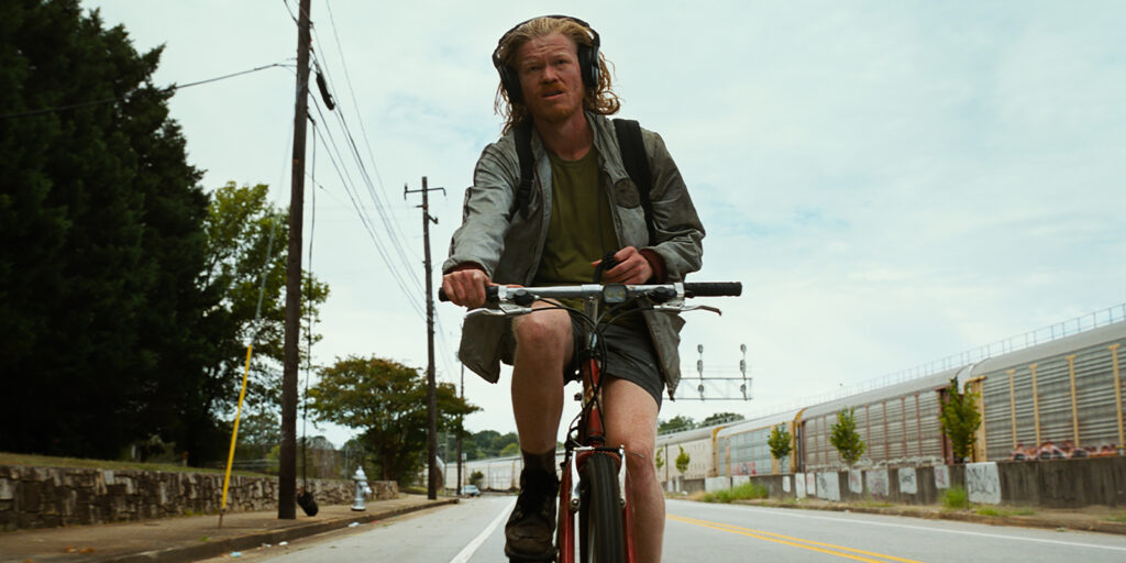 Jesse Plemons riding a bike 