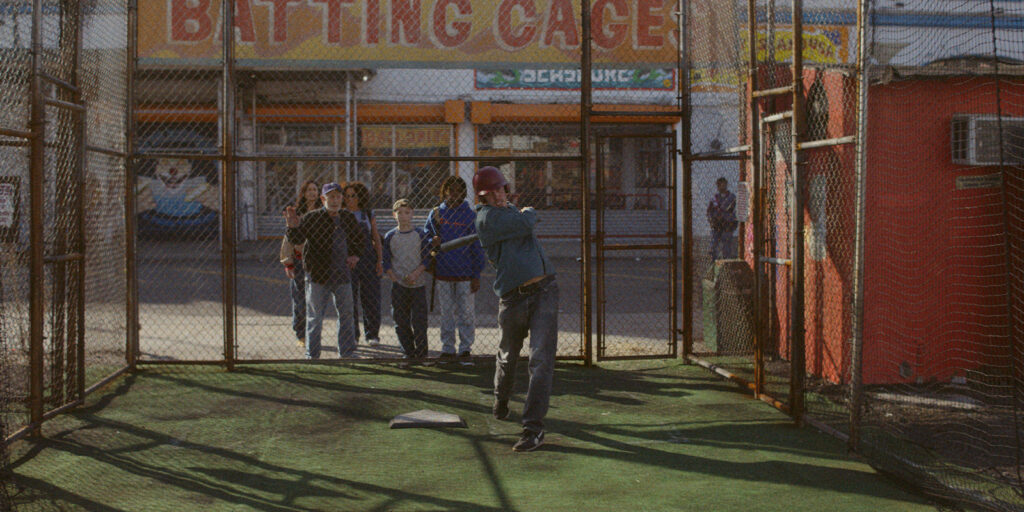 A group of people heading into a baseball court