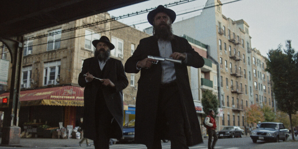 Two men walking with pistols
