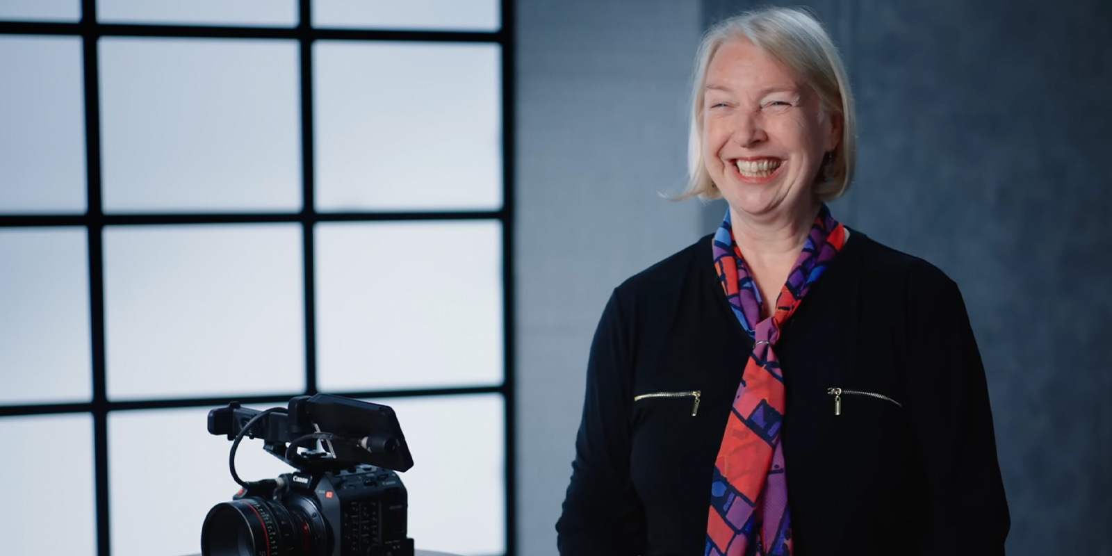 Claudia Raschke smiling in front of a camera
