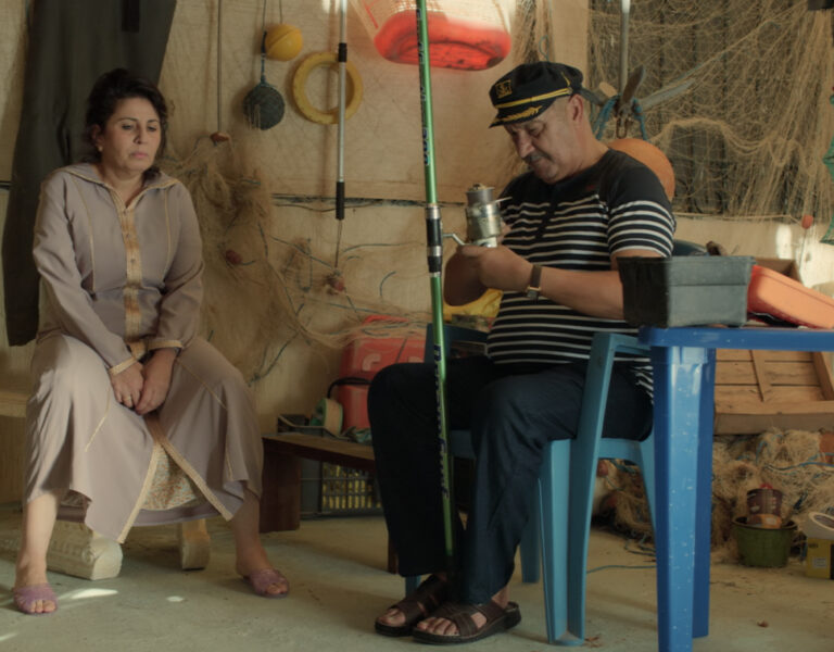 Two people sat together looking tense