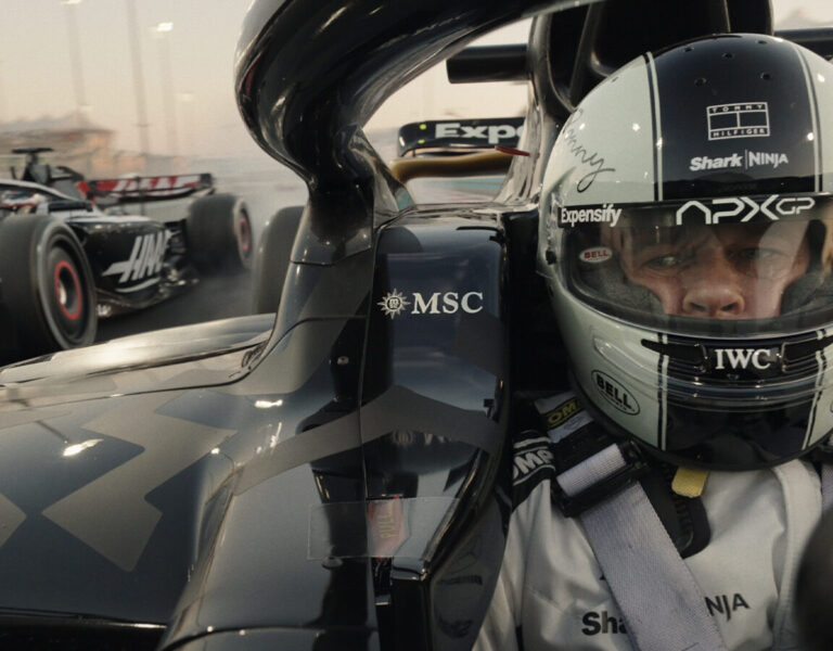 Brad Pitt in an F1 car looking in his mirror