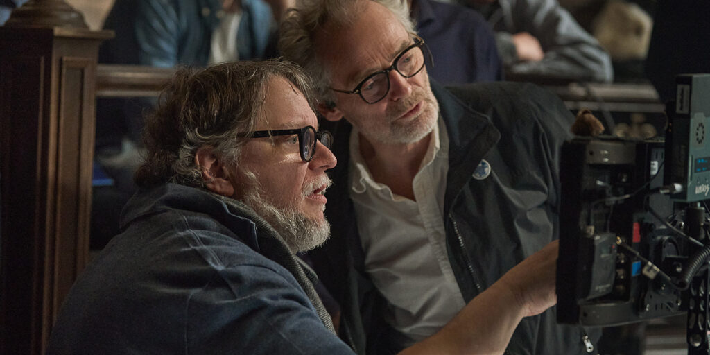 Laustsen and del Toro looking at a camera together