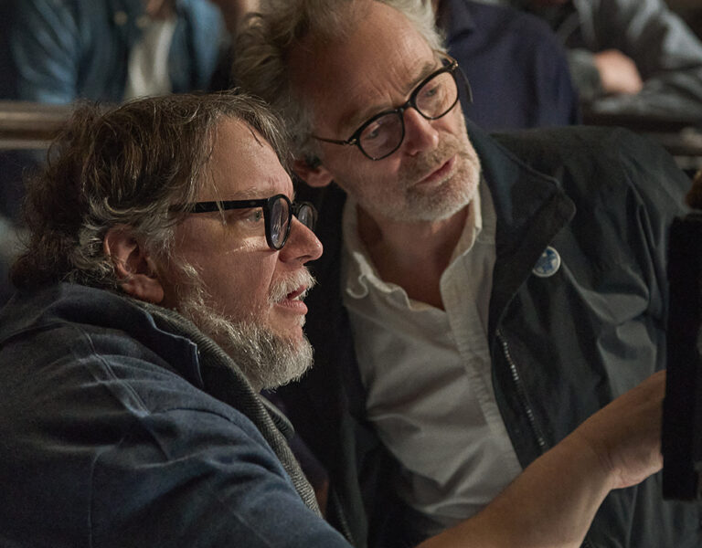 Laustsen and del Toro looking at a camera together